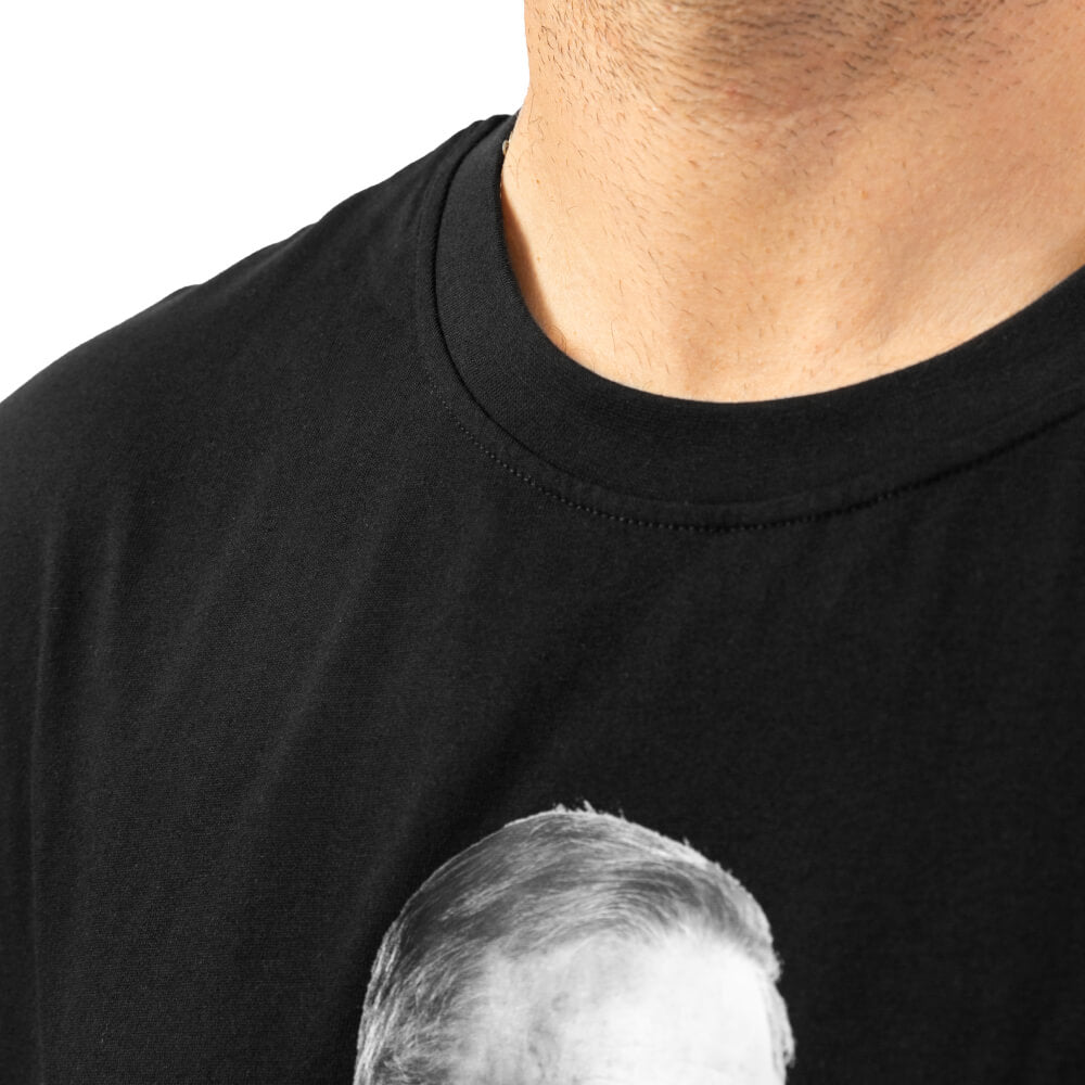 Close-up of the black Fire The Liar T-shirt’s crew neck