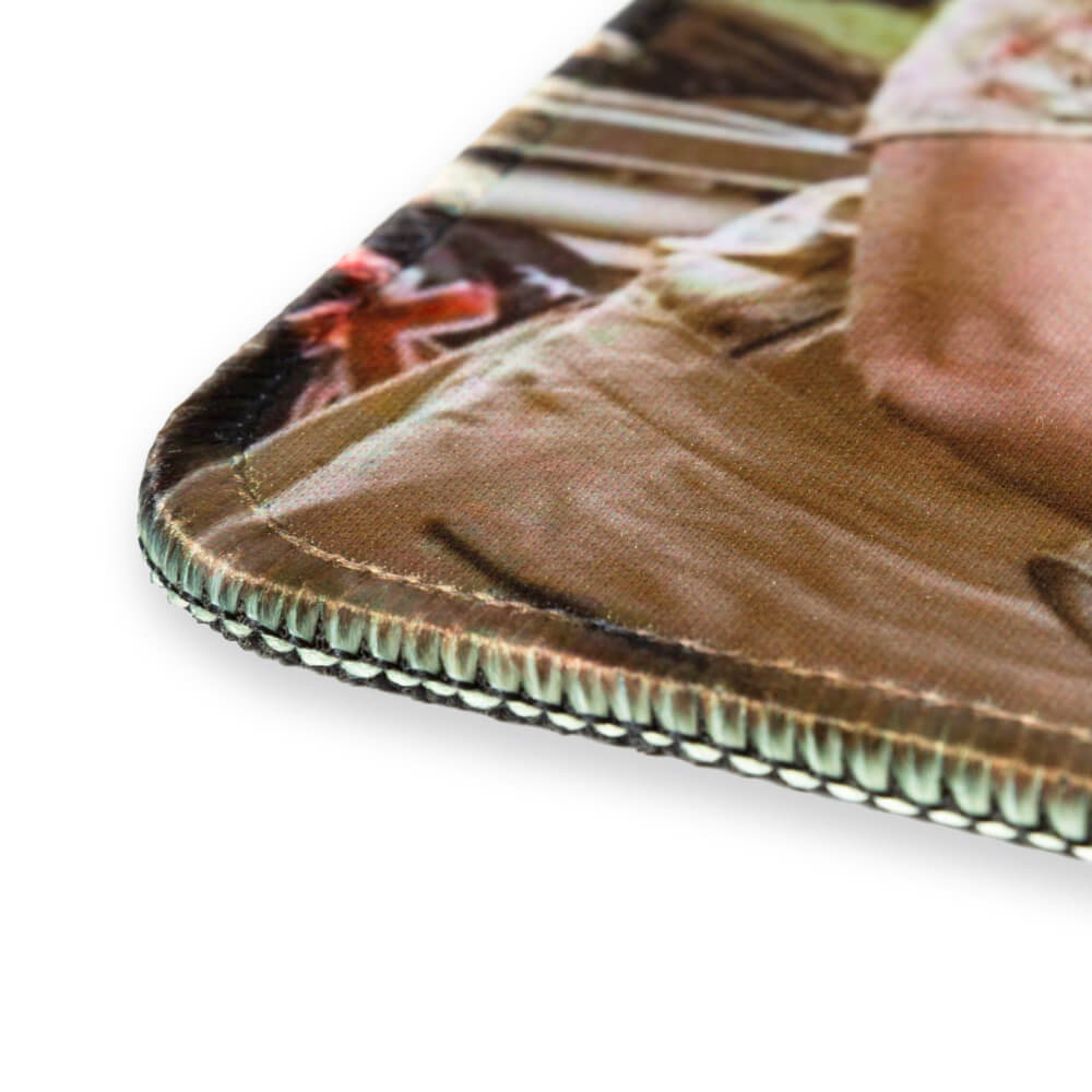 Angled close-up of the Flagging The Issues mouse pad’s stitched edge and non-slip base