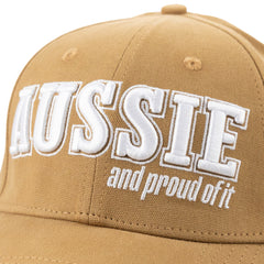 Close-up of the white “Aussie and proud of it” embroidery on the tan cap