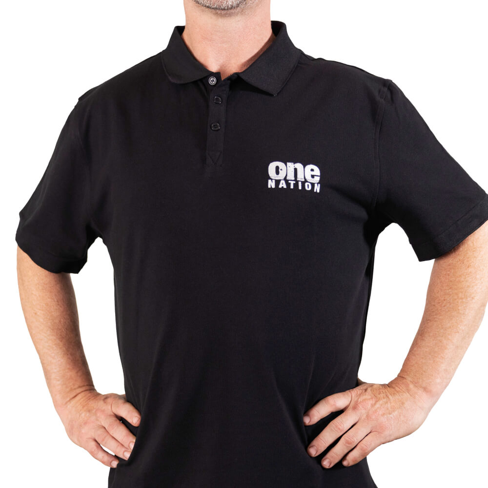 Man wearing the black One Nation polo shirt with the white logo on the chest