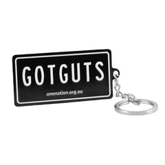 Angled view of the “GOT GUTS” licence plate keyring with split ring