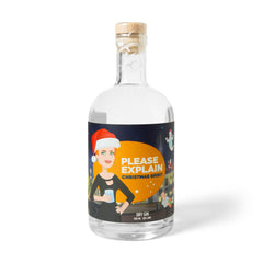 Bottle of Please Explain Christmas Spirit Gin with a cartoon Pauline Hanson in a Santa hat on the label